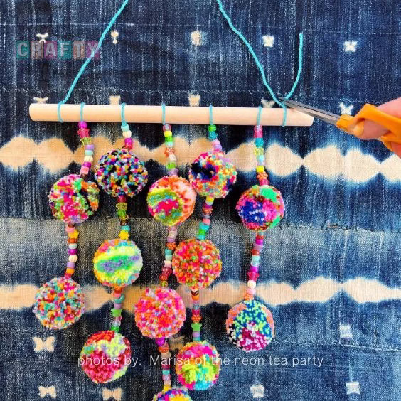 DIY Beaded Pom Pom Wall Hanging - 15 Dopamine Decor Ideas For Your Living Room - Arty Crafty Crew